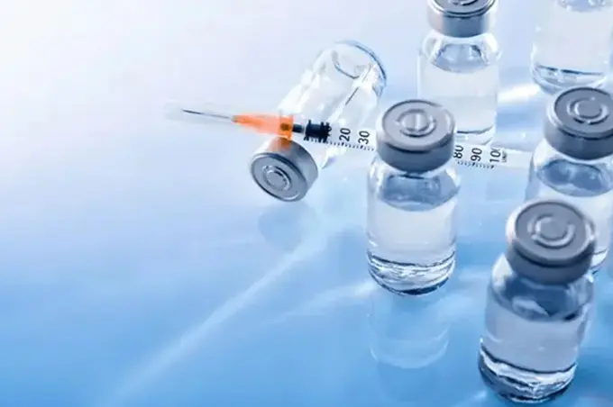 A close up of some bottles and a syringe