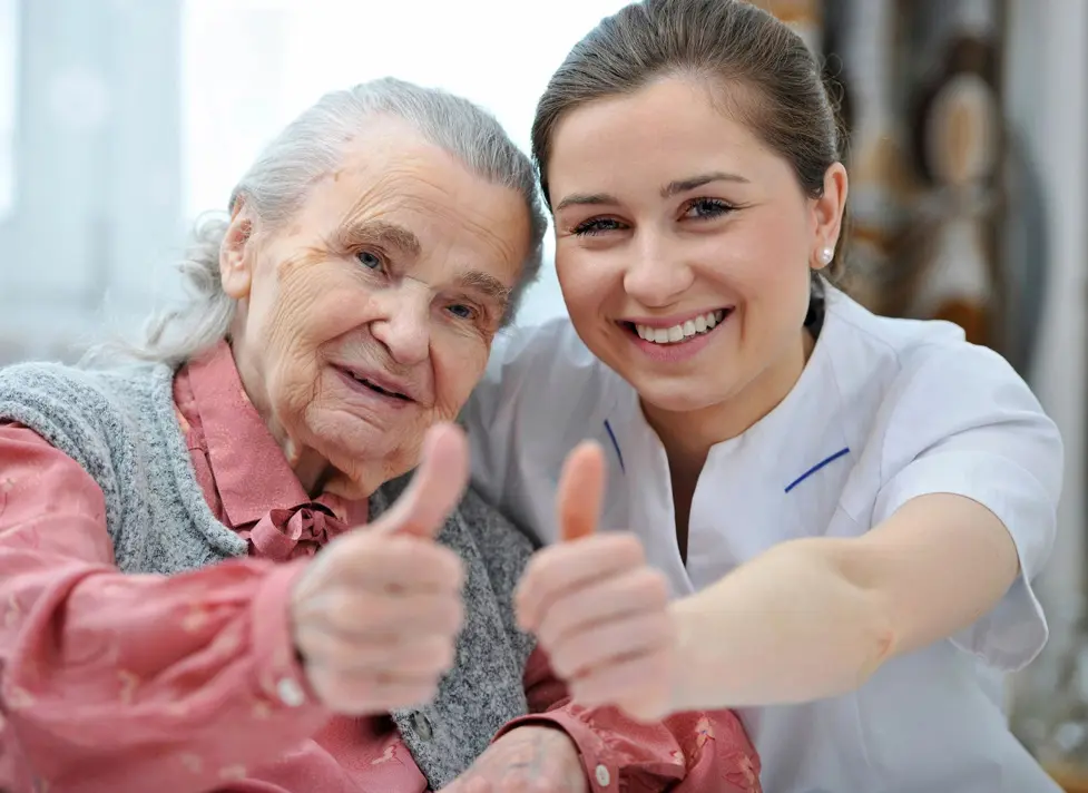 Two Women Raising Their Thumbs Out Image