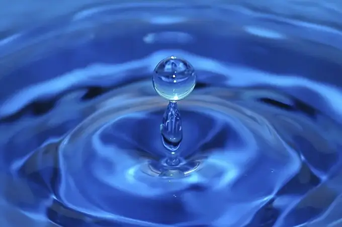 A water drop is shown in the air.